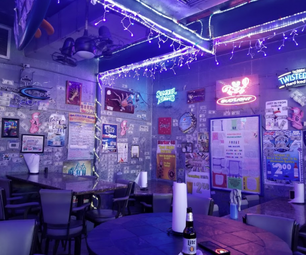 The Freezer Tiki Bar inside lit up by blue neon lights